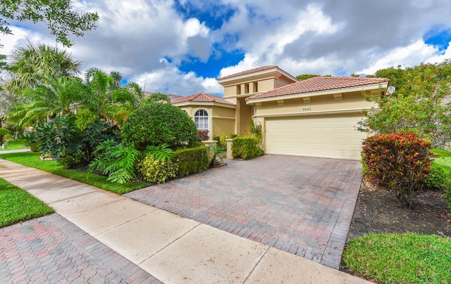 mediterranean / spanish-style home with a garage