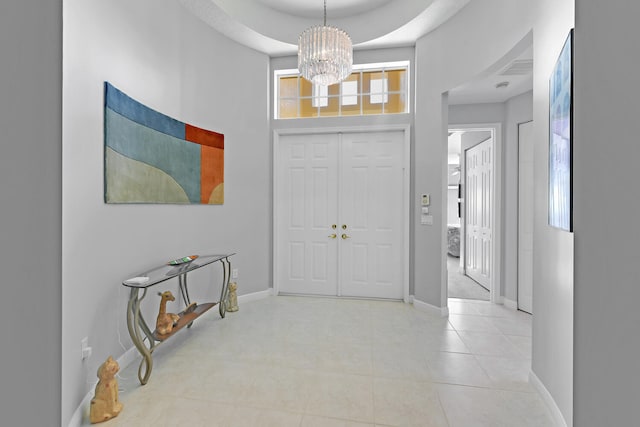 foyer entrance featuring a chandelier and a high ceiling