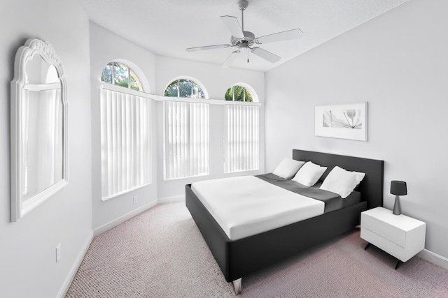 bedroom featuring light colored carpet, ceiling fan, and lofted ceiling