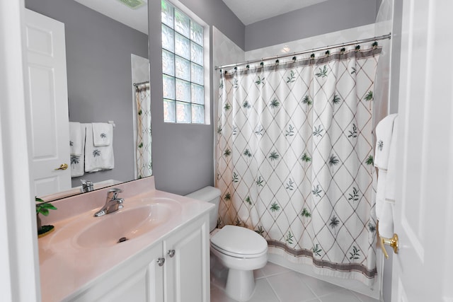 bathroom featuring tile patterned floors, walk in shower, vanity, and toilet