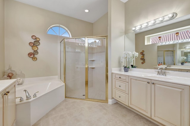 bathroom with tile patterned flooring, vanity, and separate shower and tub