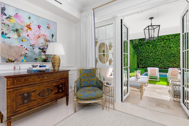 living area featuring light tile patterned floors and ornamental molding