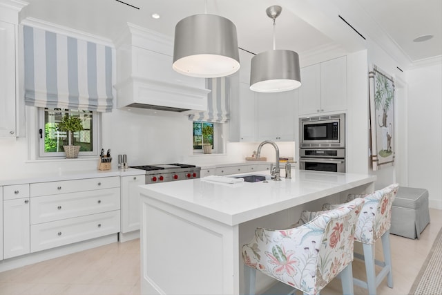 kitchen featuring a kitchen breakfast bar, stainless steel appliances, and white cabinetry