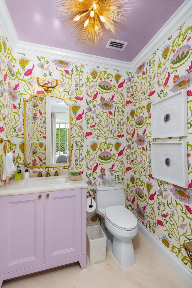 bathroom with tile patterned floors, crown molding, vanity, and toilet