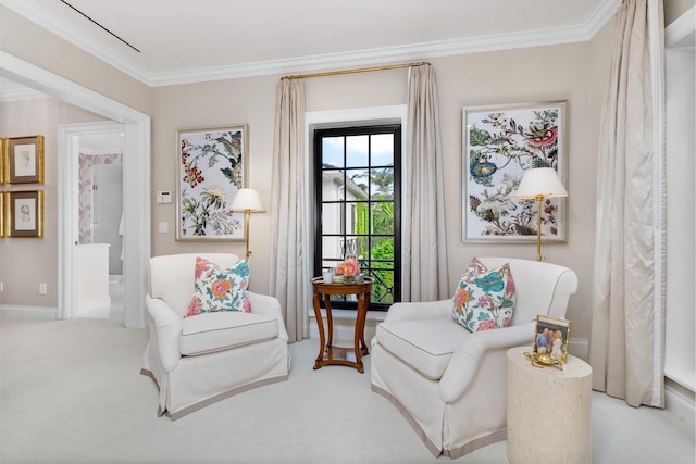 sitting room with light carpet and ornamental molding