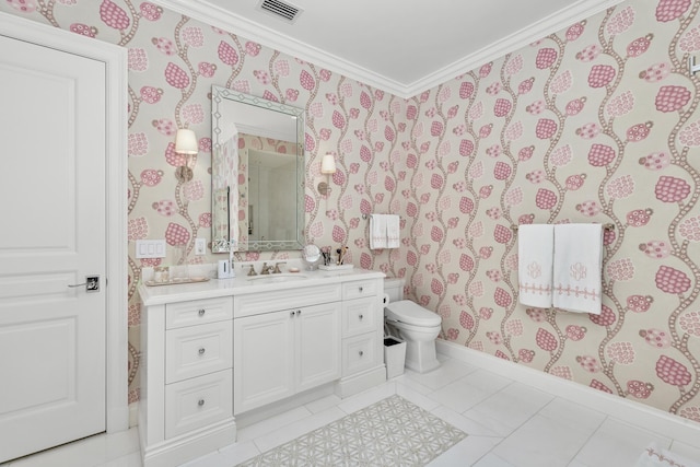 bathroom with toilet, vanity, tile patterned floors, and ornamental molding