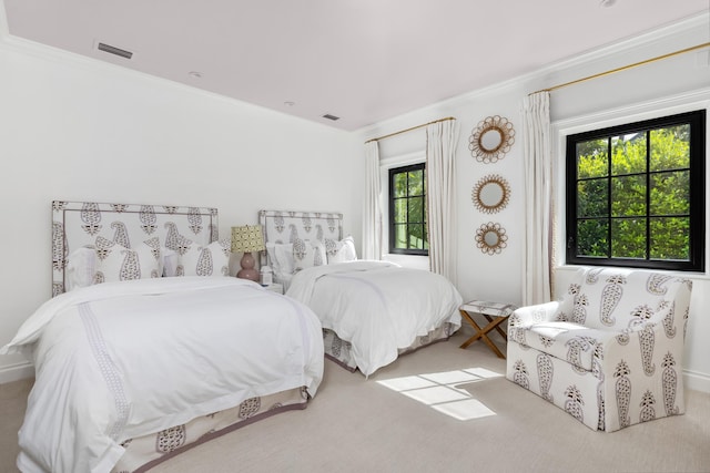 carpeted bedroom featuring crown molding