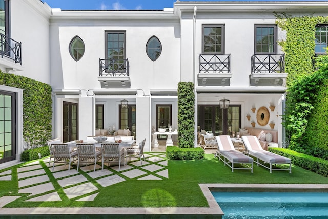 back of house with a patio area, french doors, and an outdoor hangout area