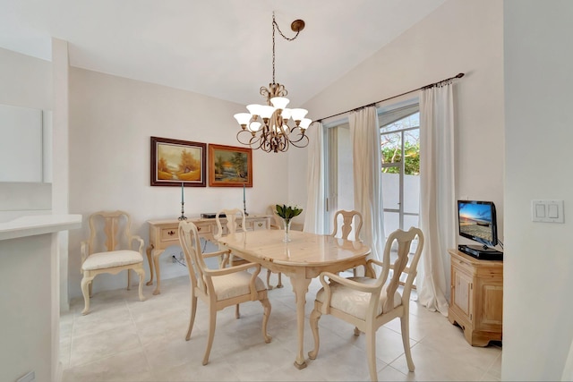 tiled dining room featuring a chandelier and vaulted ceiling