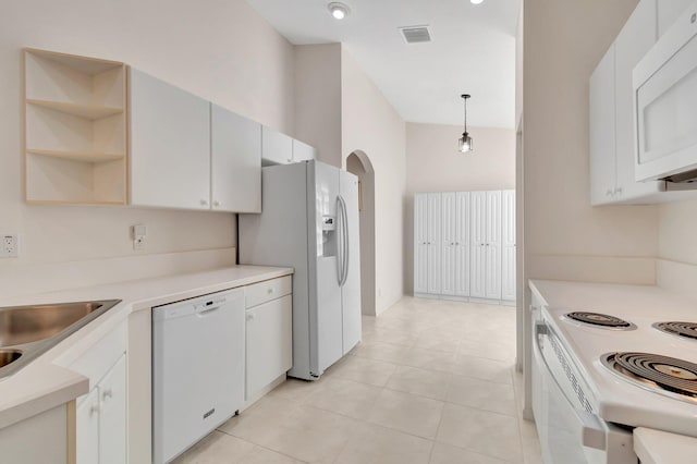 kitchen with sink, decorative light fixtures, white cabinets, white appliances, and light tile patterned floors