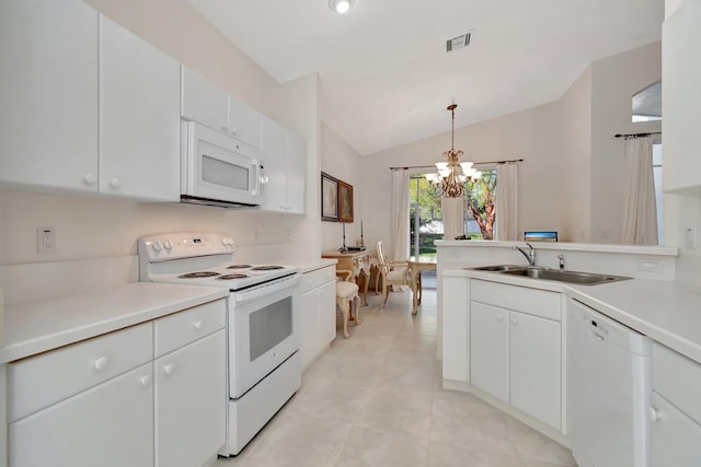 kitchen featuring white appliances, pendant lighting, and white cabinets