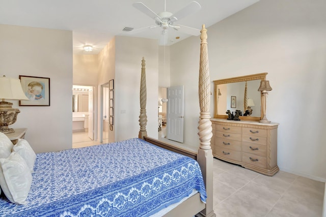 bedroom with connected bathroom, a high ceiling, tile patterned floors, and ceiling fan