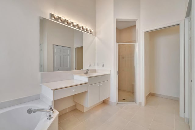 bathroom with tile patterned flooring, shower with separate bathtub, and vanity