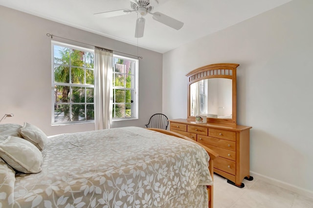 tiled bedroom featuring ceiling fan