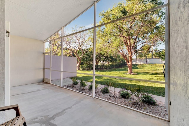 unfurnished sunroom featuring lofted ceiling