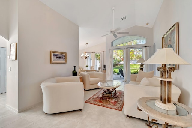 living room with ceiling fan with notable chandelier, high vaulted ceiling, french doors, and light tile patterned floors