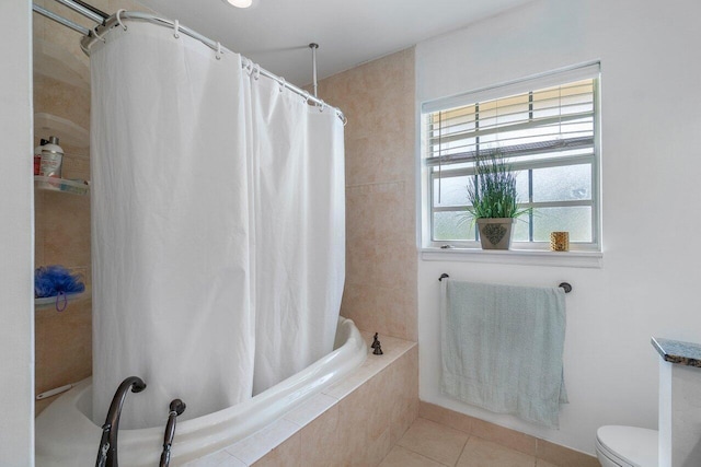 bathroom with tile patterned flooring, toilet, and shower / tub combo with curtain