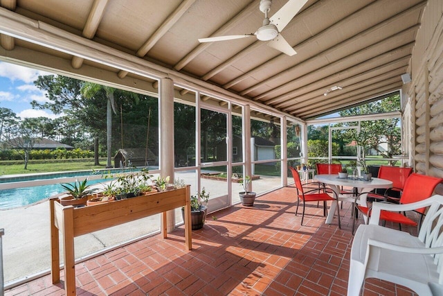 sunroom / solarium with ceiling fan and lofted ceiling