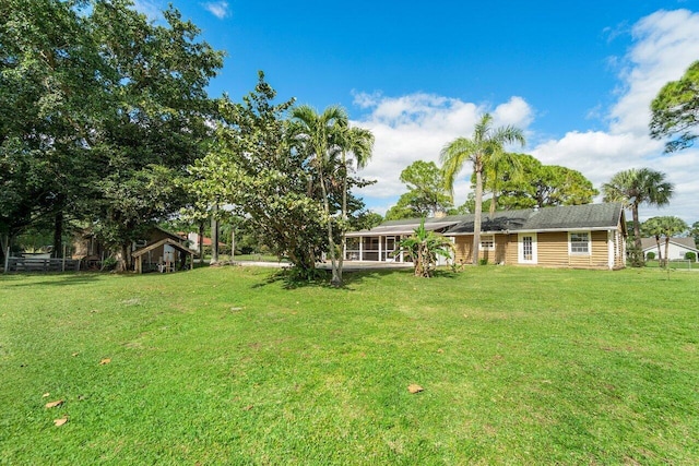 view of yard with a sunroom