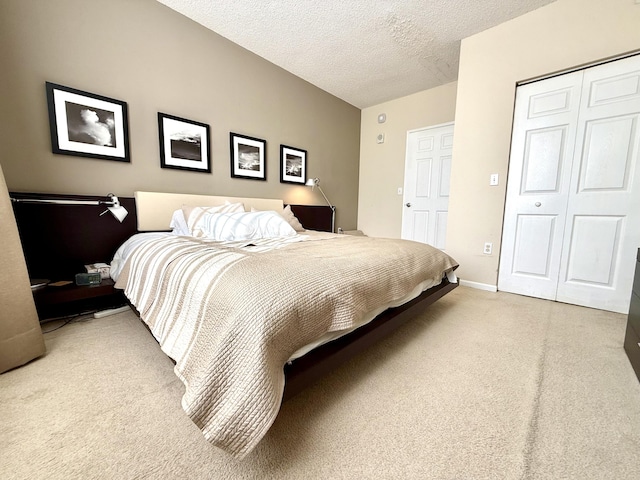 bedroom with a textured ceiling, a closet, and baseboards