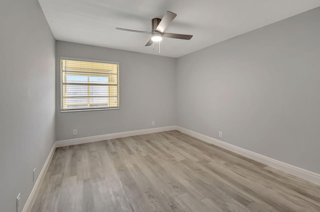 spare room with ceiling fan and light wood-type flooring