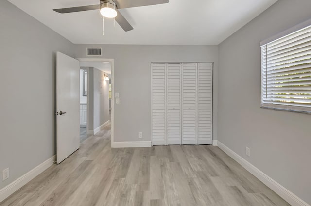 unfurnished bedroom with ceiling fan, a closet, and light hardwood / wood-style flooring