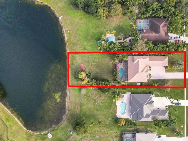 birds eye view of property with a water view