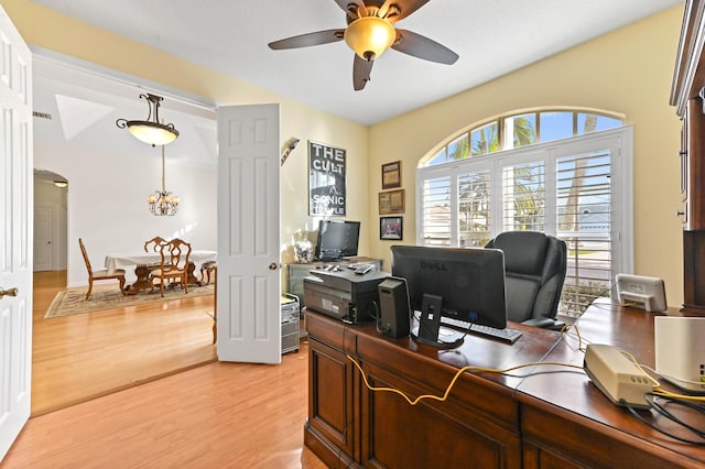 office area featuring ceiling fan with notable chandelier and light wood-type flooring