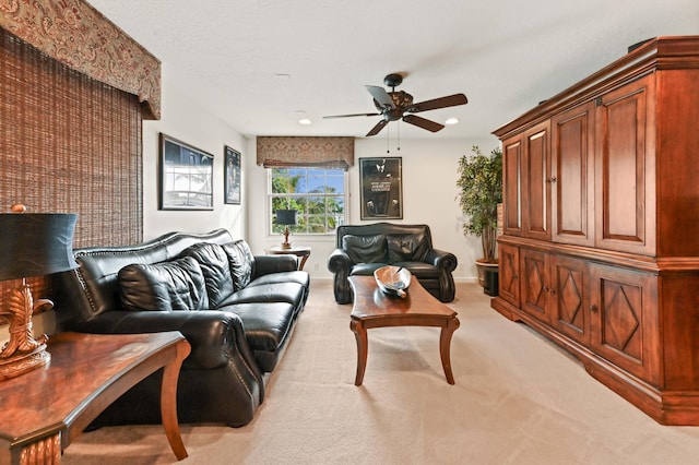 carpeted living room featuring ceiling fan