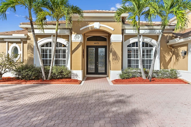 view of exterior entry featuring french doors