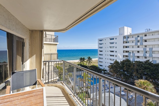 balcony with a water view and a beach view