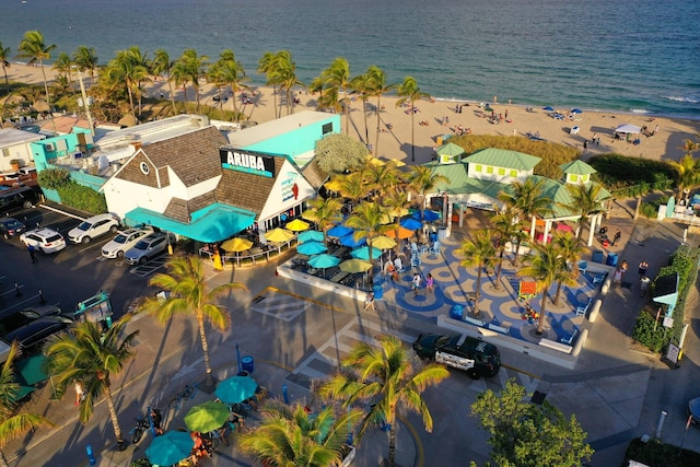 birds eye view of property with a beach view and a water view