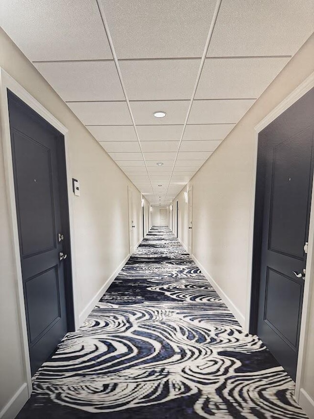 hallway with a drop ceiling