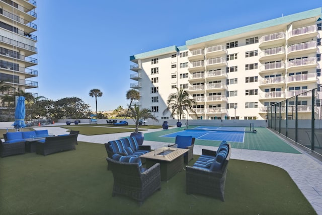 exterior space with outdoor lounge area and tennis court