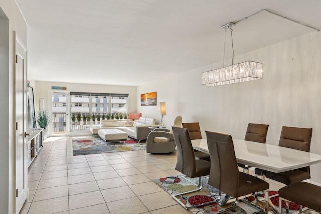 dining space with light tile patterned floors and a notable chandelier