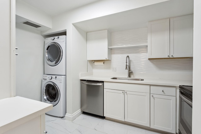 laundry area featuring sink and stacked washer and clothes dryer