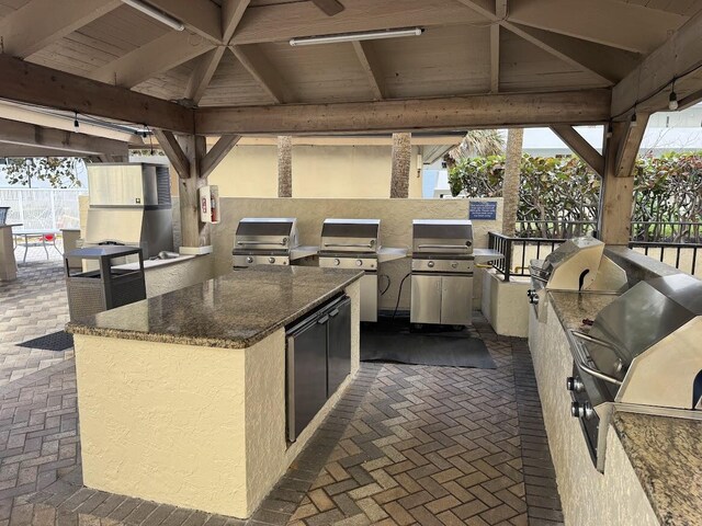 kitchen with white cabinets and stainless steel fridge