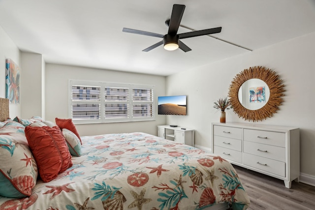 bedroom featuring ceiling fan and dark hardwood / wood-style flooring