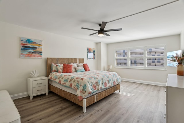 bedroom with hardwood / wood-style floors and ceiling fan