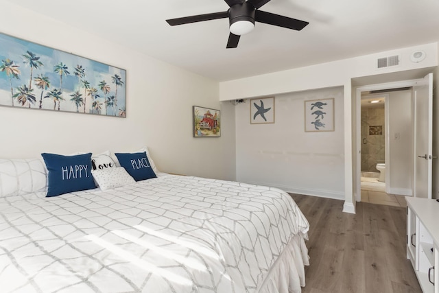 bedroom featuring hardwood / wood-style floors, ceiling fan, and ensuite bathroom