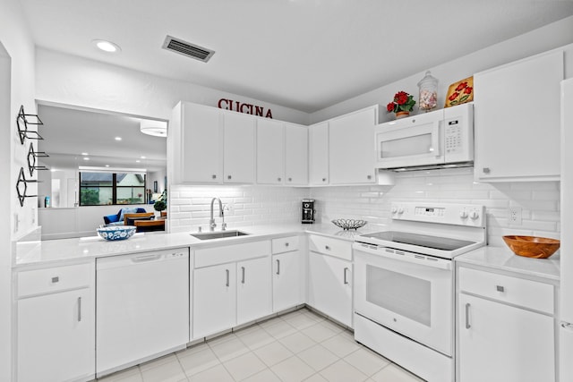 kitchen with white cabinetry, sink, tasteful backsplash, and white appliances