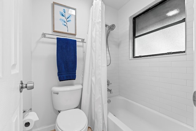 bathroom with toilet and shower / tub combo