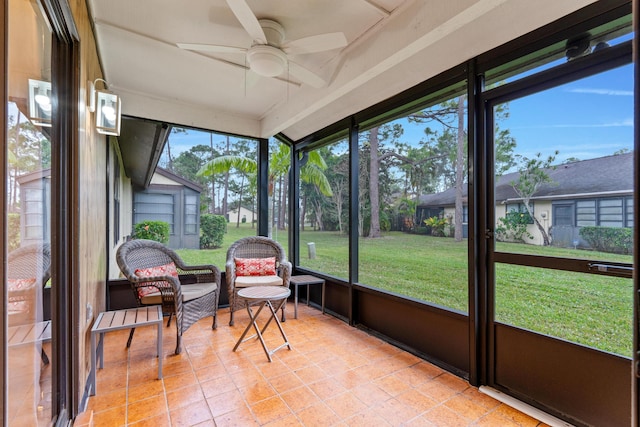 sunroom / solarium featuring ceiling fan