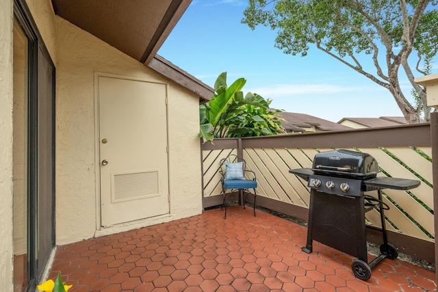 view of patio featuring a grill and a balcony