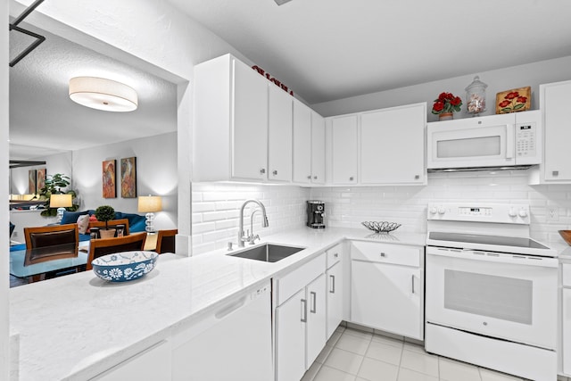 kitchen with white appliances, white cabinets, sink, backsplash, and light tile patterned floors