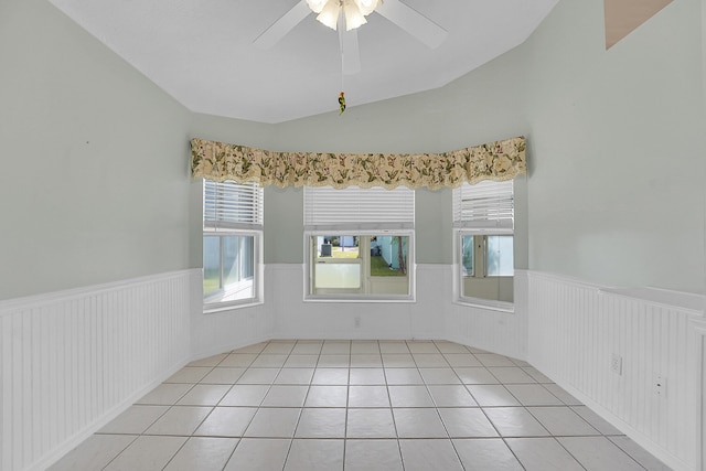 tiled spare room featuring ceiling fan