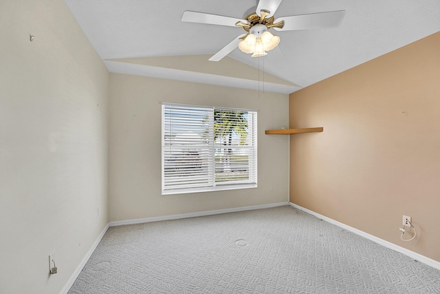 spare room featuring carpet flooring, ceiling fan, and vaulted ceiling