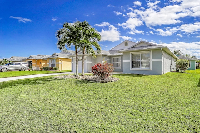 ranch-style house featuring a garage and a front lawn