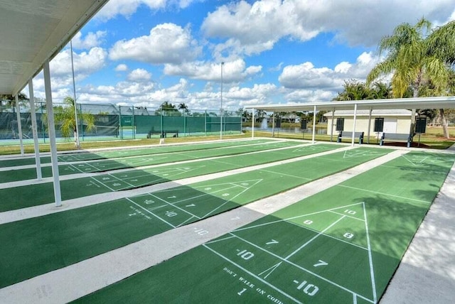 view of community featuring tennis court