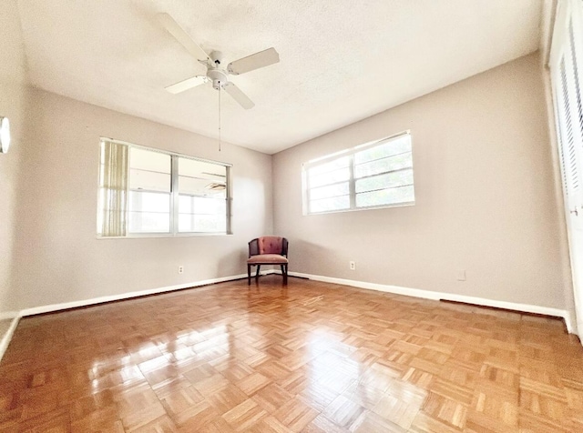 interior space featuring light parquet flooring and ceiling fan